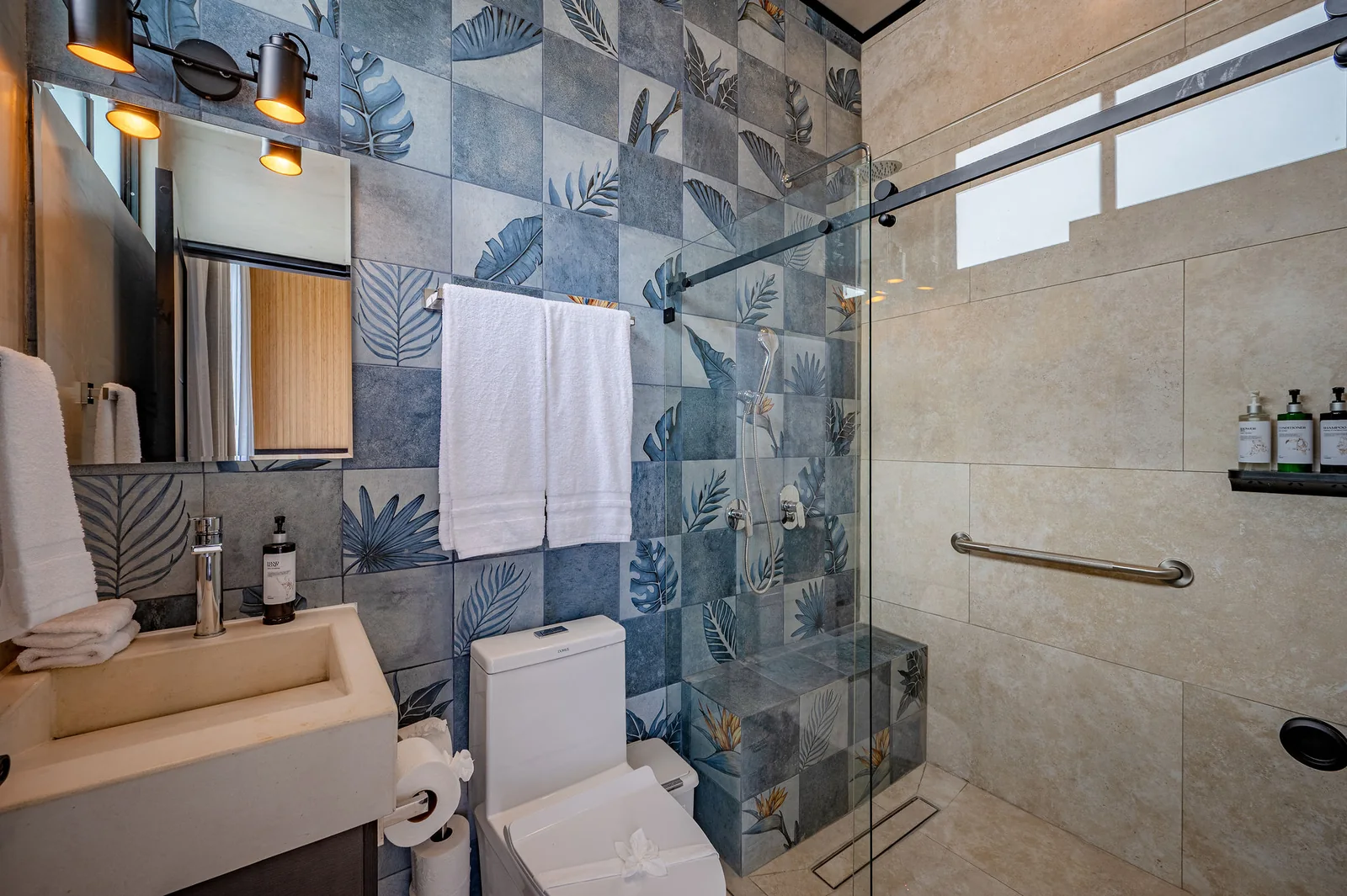 Ensuite bath with botanical tile and glass shower