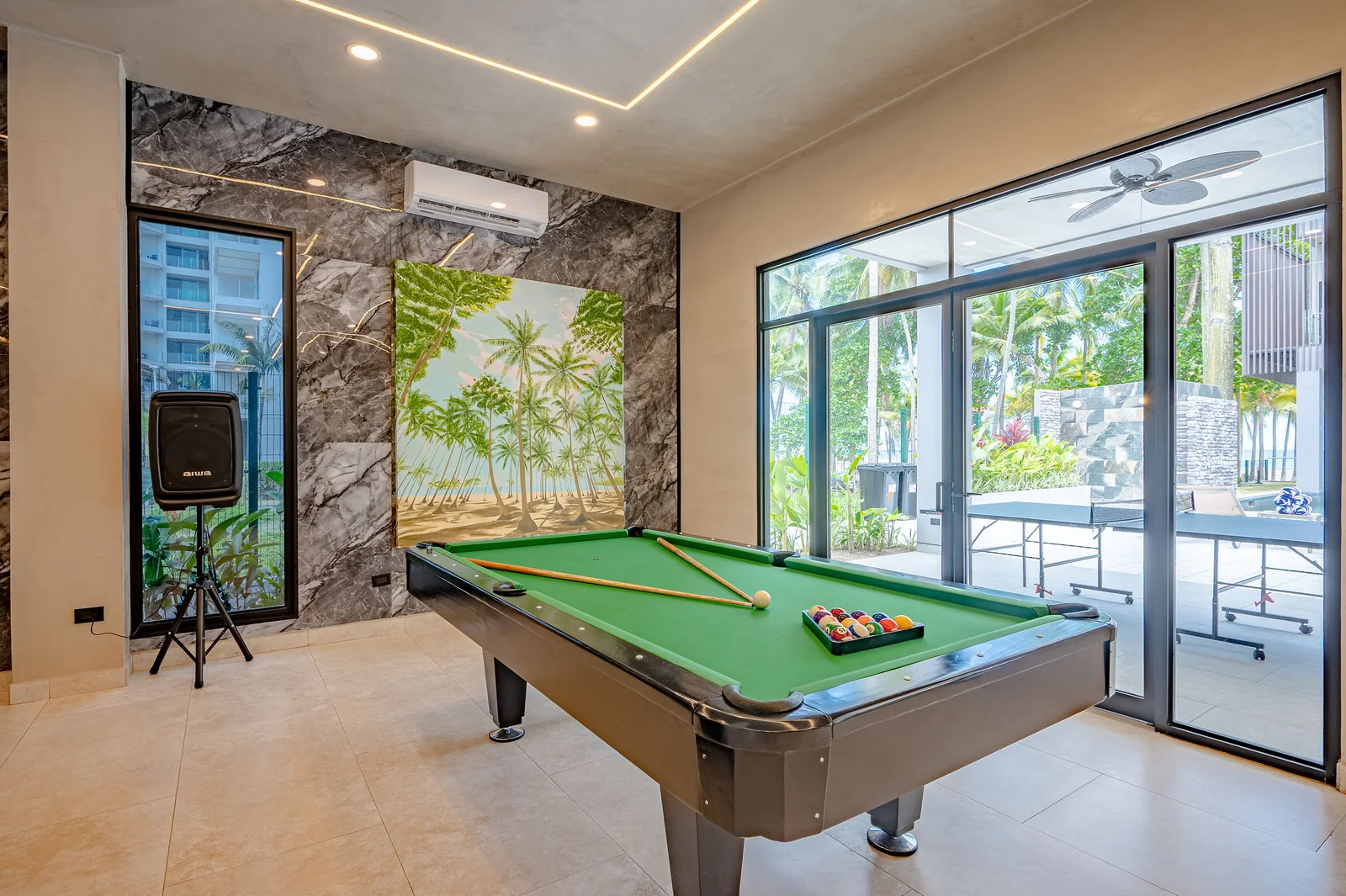 Air-conditioned games room with a full-size pool table, ping pong and foosball