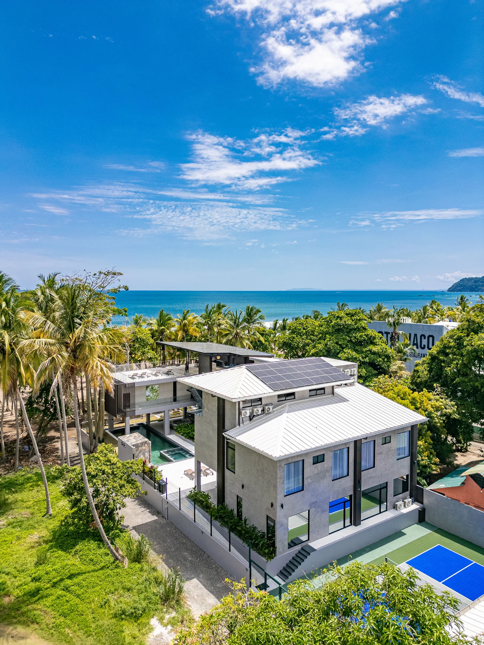 Wide aerial of Casa Las Palmas and Jaco bay