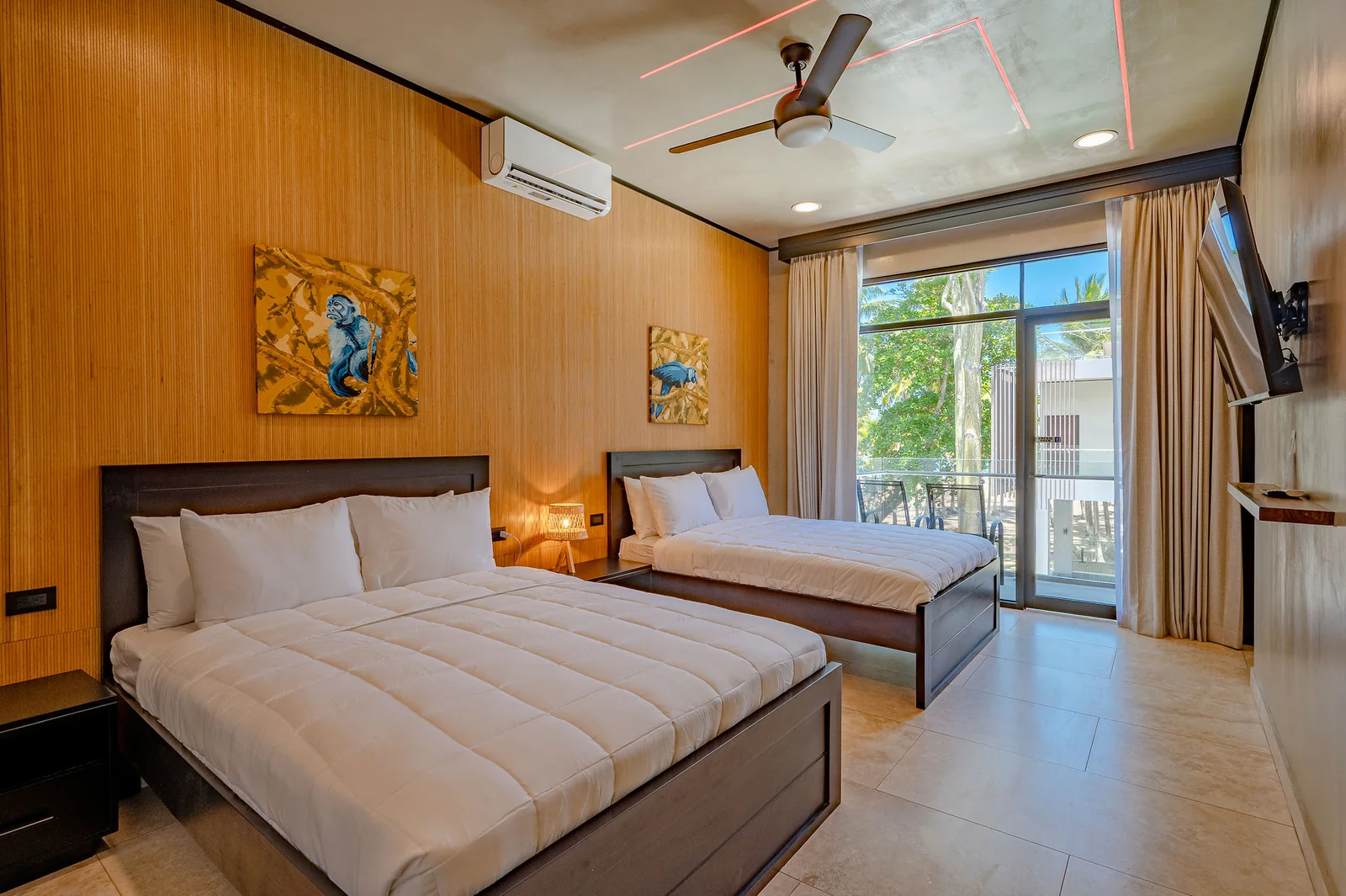 Double-queen bedroom with macaw artwork